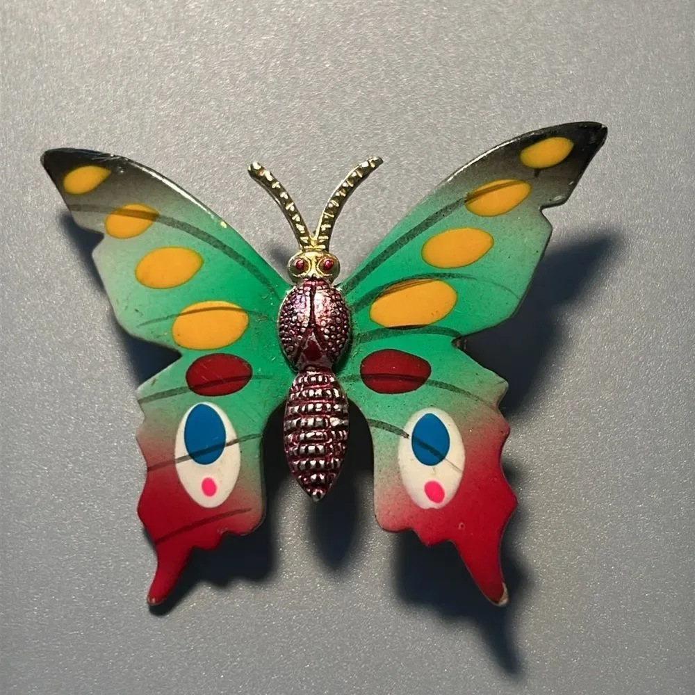 Vintage pointsettia and butterfly enamel on metal brooch set